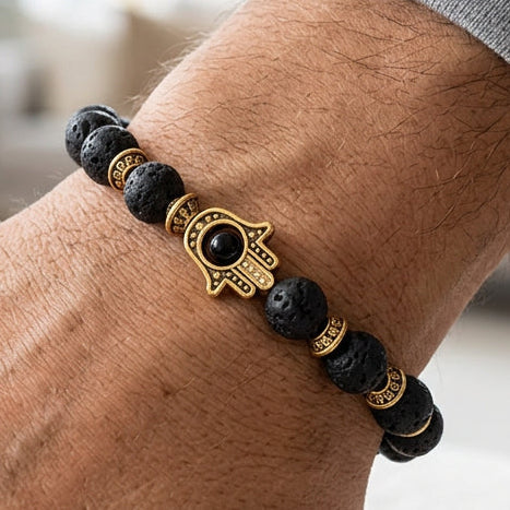Pulsera de piedra de lava con Hamsa dorada · NŪMEN MIND